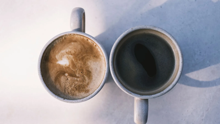 A milky coffee and a black coffee side by side, seen from above