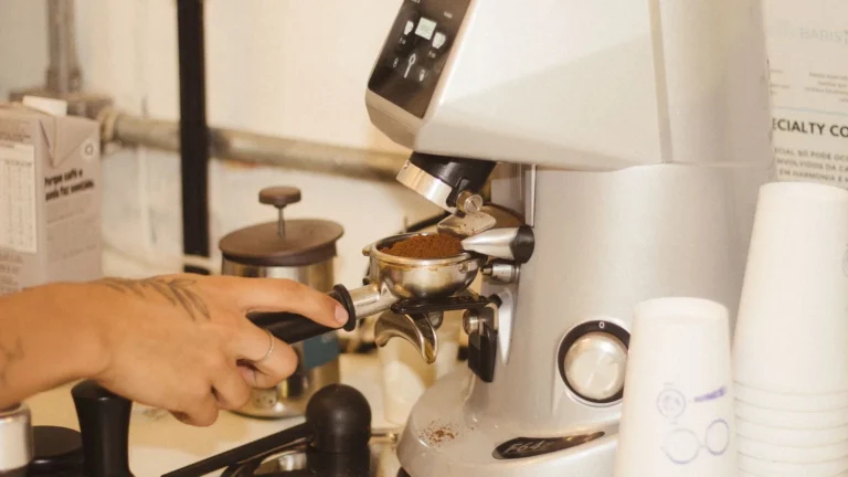 Modern electric espresso grinder dosing grounds into a portafilter